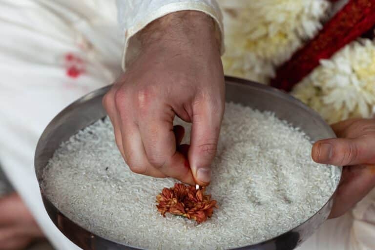 Close-up of a hand. At an international wedding, a fair-skinned man in the Hindu