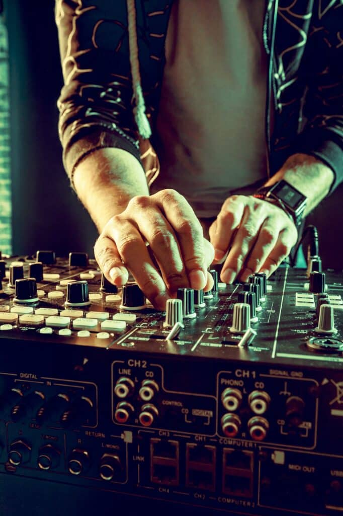 DJ playing music at mixer closeup
