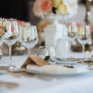 Beautiful table served with glassware and cutlery, decorated with flowers