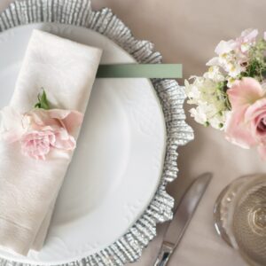 Delicate wedding table setting. A plate with a napkin and a rose.