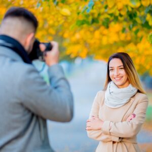 Young photographer with camera and model