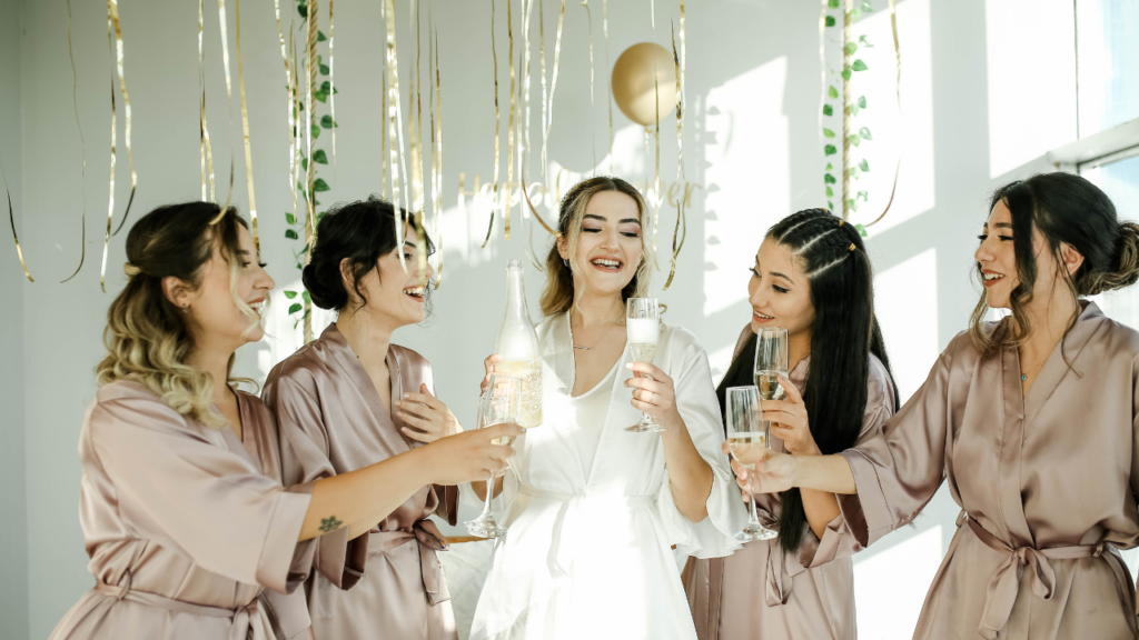 Bride in vintage-inspired gown with dramatic veil and bold jewelry, reflecting top wedding trends 2025.