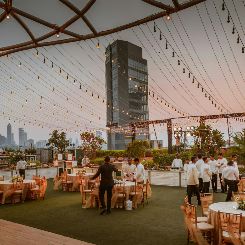 vnv events: Wedding decor ideas in Florida - "young smiling florist showing white floral decor to event manager with clipboard in event hall"-2