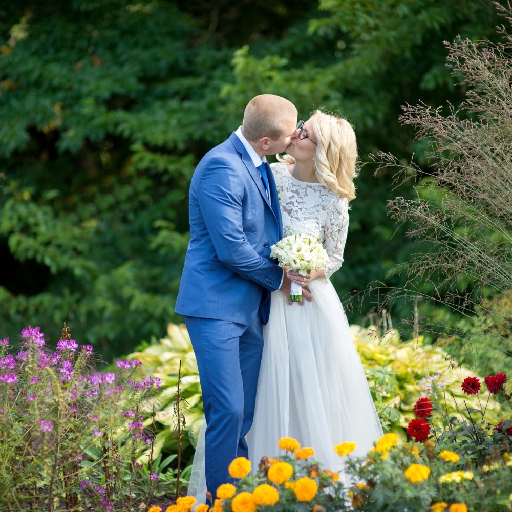 bride and groom walking in the botanical garden