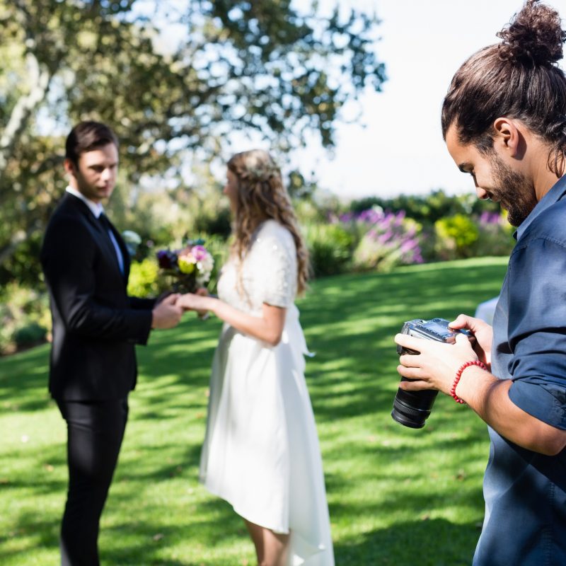 Photographer reviewing photographs on digital camera