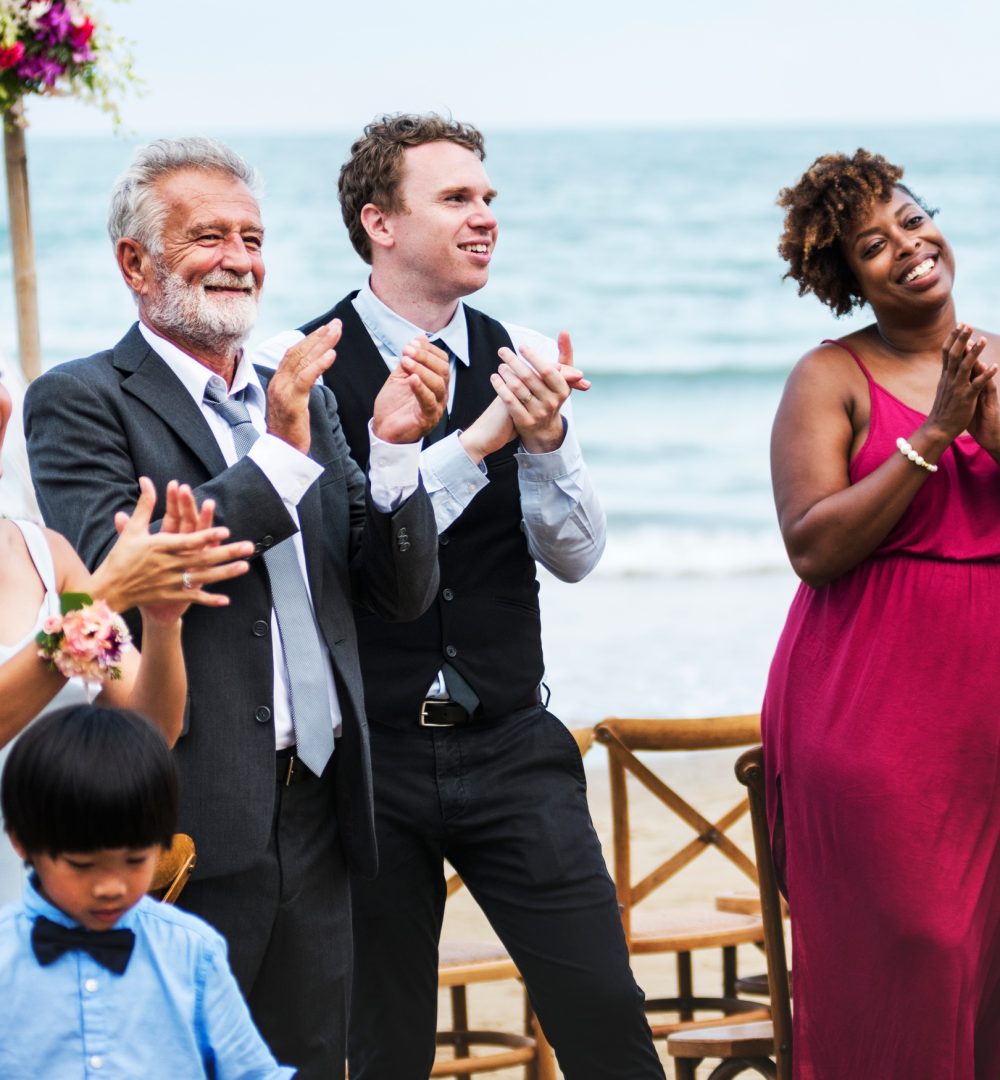 Wedding guests clapping for the bride and groom